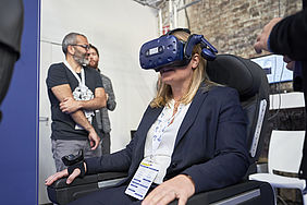 Sitting on a real airplane seat, users wore a headset to interact with a VR-immersive environment simulating the fuselage of an airplane.